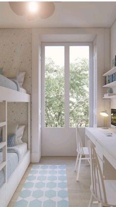 a bedroom with bunk beds and desks in front of a window that looks out onto the trees