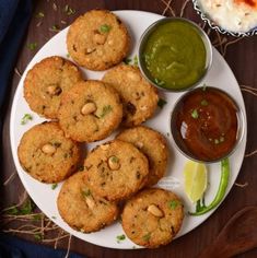 several cookies on a plate with dipping sauces