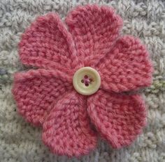 a crocheted flower with a button on it