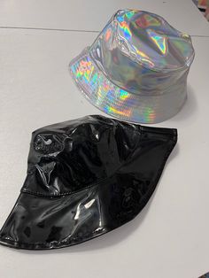 Holographic or black vinyl hat. Hats measure 23 inches Note: please measure your head. I don't appreciate bad reviews from buyers who don't measure and who don't read the measurements.  Thank you in advance. perfect for every day street wear!  Partnered design by Glitz & Candy Co.  Check them out on Facebook & Etsy! Drop-shipped by Glitz & Candy Co. Trendy Festival Bucket Hat With Short Brim, Adjustable Bucket Hat For Party, Trendy Short Brim Bucket Hat For Festivals, Trendy Bucket Hat For Music Festival, Black Curved Brim Bucket Hat For Festivals, Trendy Bucket Hat For Party, Trendy Party Bucket Hat, Adjustable Black Harajuku Style Hat, Black Adjustable Harajuku Hat