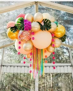 a bunch of balloons that are hanging from a ceiling