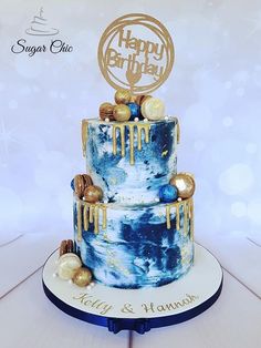 a blue and white cake with gold decorations