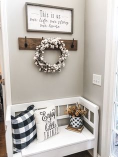 the entryway is decorated with wreaths and pillows