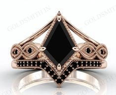 a black diamond ring with diamonds on the sides and an intricately designed band in rose gold