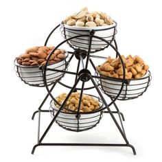 a metal stand with four baskets filled with nuts on it's sides and the top tier is black