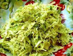 a close up of a plate of food with broccoli sprouts and tomatoes