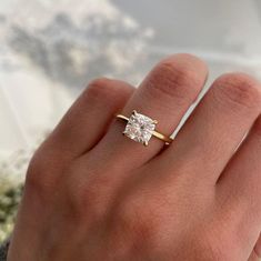 a woman's hand with a diamond ring on it