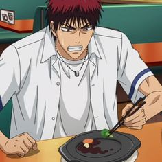 a man with red hair eating food at a table