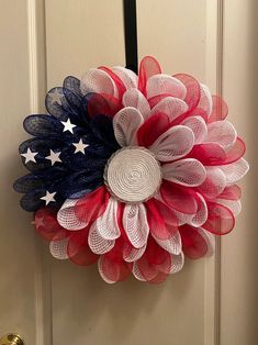 a patriotic wreath hanging on the front door