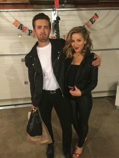 a man and woman standing next to each other in front of a garage door with the caption saying, damn and sandy from greece for halloween birds diy costume