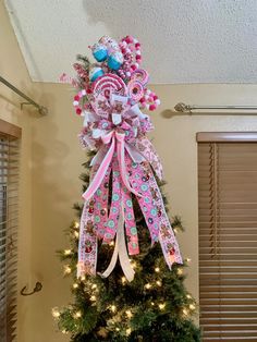 a decorated christmas tree with pink and blue bows