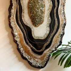 a piece of art made out of agate and black glass with silver flecks