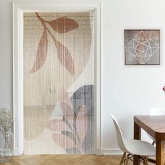 a dining room with a table and chairs next to a window covered in bamboo blinds