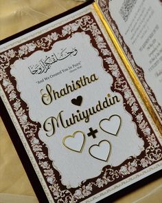 an islamic wedding card with two hearts on it