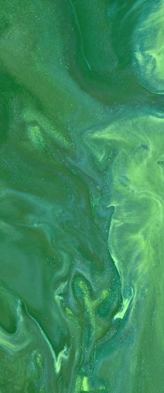 green and blue swirls in the water, as seen from an aerial view looking down