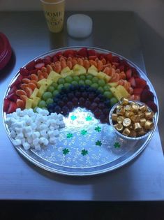 a platter filled with fruit and marshmallows on top of a table