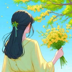 a woman holding flowers in her hand and looking up at the tree with yellow flowers on it