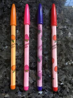 three pens sitting on top of a counter next to each other