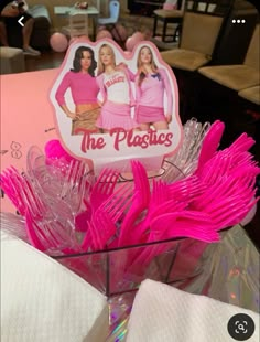 pink plastic utensils in a basket with the logo of the plastics on it