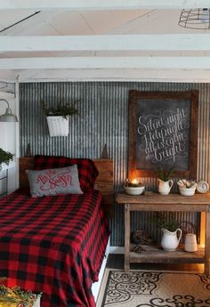 a room with a bed, table and potted plants on the shelf next to it