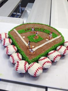 a baseball themed cake is sitting on a table