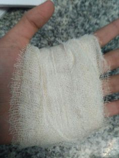 a hand with a bandage on it sitting on top of a counter