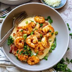 a white bowl filled with shrimp and grits