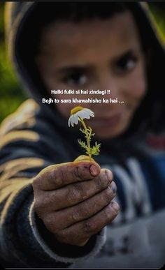 a young boy holding a flower in his hand with a quote above it that reads,