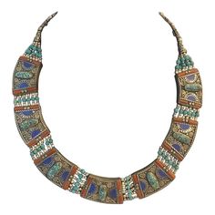 This is part of Chairish’s Fine Jewelry assortment.  This Tibetan Nepalese Tribal Necklace with Inlay Turquoise, Lapis and Carnelian Beads is even prettier in person. If you want to make a stunning statement, this vintage necklace with 100% hand-crafted workmanship and beautiful inlay compressed Turquoise and Coral beads does the job. It’s truly a one of a kind, show-stopper.  Condition: Excellent vintage condition with no missing stones; please see pics for details. Measures: Length of the neck Bohemian Blue Multi-stone Turquoise Necklace, Blue Multi-stone Bohemian Turquoise Necklace, Multicolor Adjustable Traditional Turquoise Necklace, Traditional Multicolor Necklace With Inlay, Traditional Blue Turquoise Necklace With Inlay, Traditional Multi-stone Beaded Necklaces With Round Beads, Traditional Blue Inlay Necklaces, Traditional Blue Necklaces With Inlay, Traditional Blue Necklace With Inlay