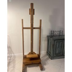 a wooden easel sitting on top of a tiled floor