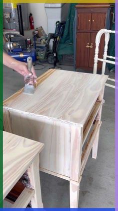 a person sanding wood with a spray bottle