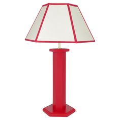 a red table lamp with a white shade