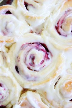 a pan filled with cinnamon rolls covered in icing