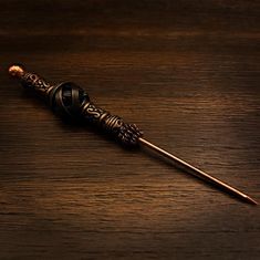 a harry potter wand sitting on top of a wooden table