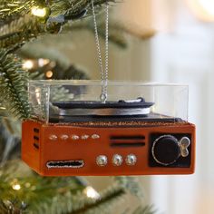 an orange radio ornament hanging from a christmas tree