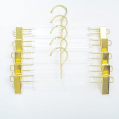 three pieces of yellow metal hangers on a white background