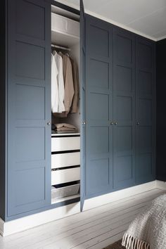 a bedroom with blue cabinets and white floors