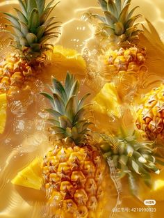 three pineapples floating on top of each other in the water with yellow background