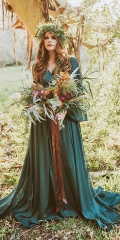 a woman in a green dress holding a bouquet