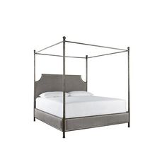 an iron bed frame with white sheets and grey linens on the bottom, against a white background