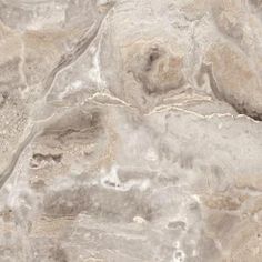 a close up view of the surface of a stone wall with white and brown colors