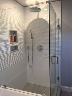 a bathroom with a walk in shower next to a bath tub