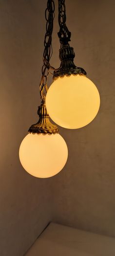 two lights hanging from a ceiling in a room