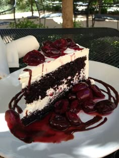 a piece of cake with cherries on it sitting on a plate