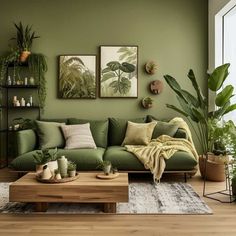 a living room with green walls and plants on the wall