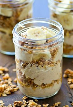 two jars filled with granola and banana slices