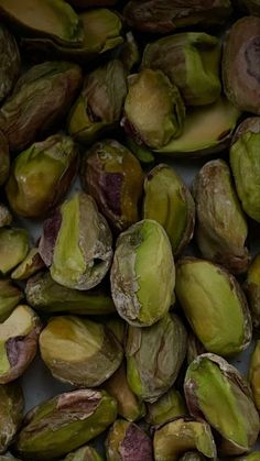 pistachio nuts are shown in this close up shot, with the kernels still intact