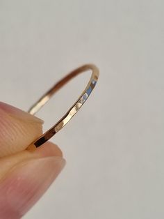 Description This skinny stacking ring has been hand formed from 1mm 14k Gold Filled* wire. It has been delicately hammered by hand to add a subtle dimpled texture. It can be stacked easily with other stackable rings (see other items in my shop), or with your own jewellery, to create a range of textures and styles. This ring is also available in eco silver. Your ring(s) will arrive on a branded card as shown in the photo. On multiple ring orders, please let me know if you require individual packa Multiple Rings, Gold Rings Stackable, Stackable Ring, Oils For Skin, Display Cards, Stacking Ring, Ring Gold, Stackable Rings, Stacking Rings