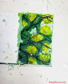 an open book with green and yellow leaves on it