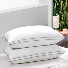 two pillows are stacked on top of each other